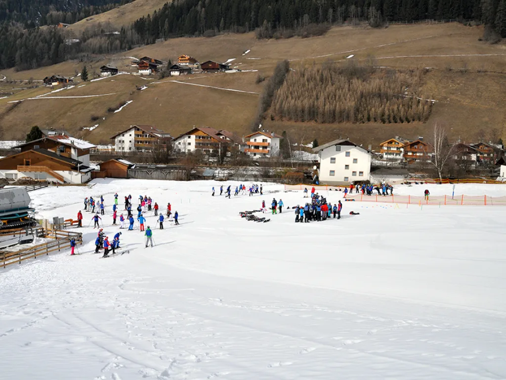 Blick über die Übungswiese auf den Ort und die aperen Hänge.